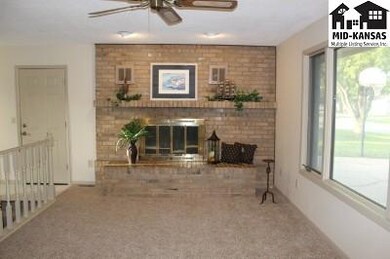 Living room has wood burning fireplace and great n