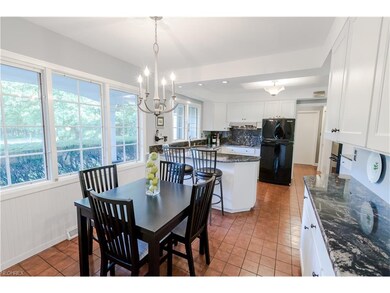 The updated eat in kitchen features white cabinets