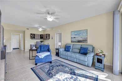 Living area featuring visible vents and light tile