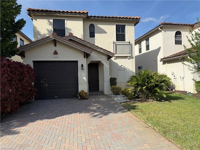 Mediterranean / spanish-style home featuring stucco siding, a tiled roof, decorative driveway, and a front lawn