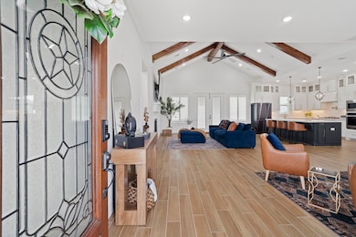 Spacious open-concept living area with high vaulte
