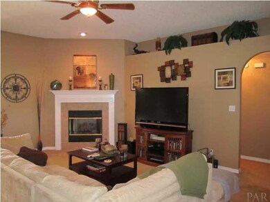Living Room - Features a high ceiling, gas fireplace, and plant ledges