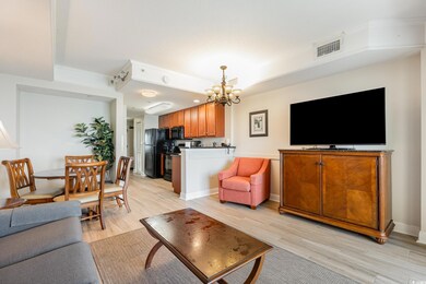 Living room with a notable chandelier and light wo