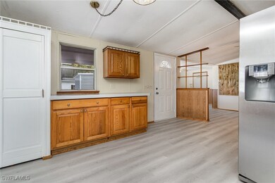 Kitchen with light hardwood / wood-style flooring