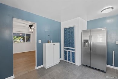 Kitchen featuring stainless steel fridge, ceiling fan, and electric panel