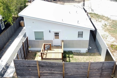 Back of property featuring a fenced backyard and crawl space