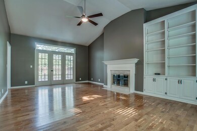 Very large living room with vaulted ceiling, wood burning fire place, lots of windows and access to the deck. 