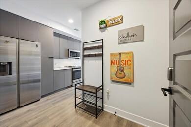 Kitchen featuring stainless steel appliances, lig