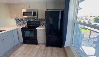 Kitchen featuring light wood-type flooring, backsp