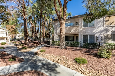 View of front facade with stucco siding and stairs