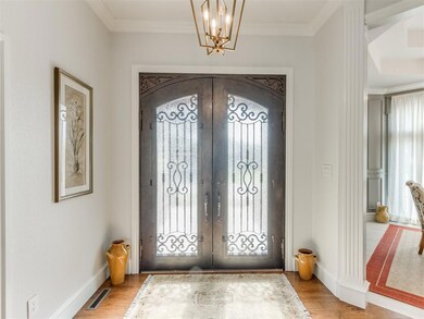 Entryway with french doors, crown molding, light h