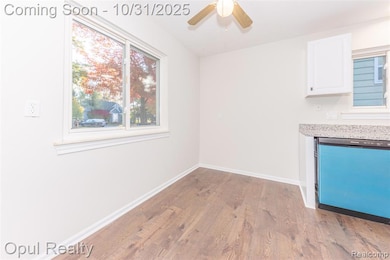 Unfurnished dining area with light wood-type flooring and a ceiling fan