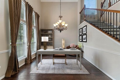 Inviting home office with high ceilings and an abundance of natural light, creating a bright and inspiring workspace.  Virtually staged.