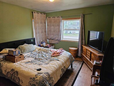 Bedroom with parquet flooring