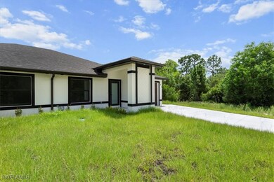 Back of property featuring stucco siding and roof