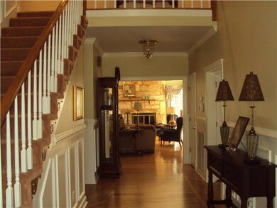 2 Story Foyer with gleaming hardwood floors.