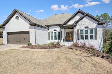View of front of house with a garage, a front lawn