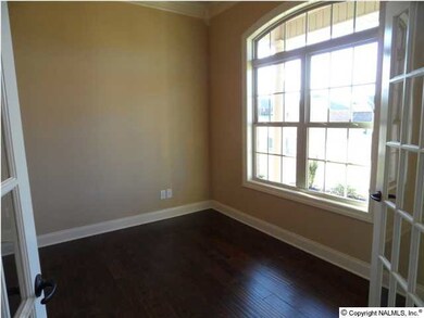 Living / Study has 10 foot ceilings, wood flooring, 15 lite doors to close off the area, ceiling fan.