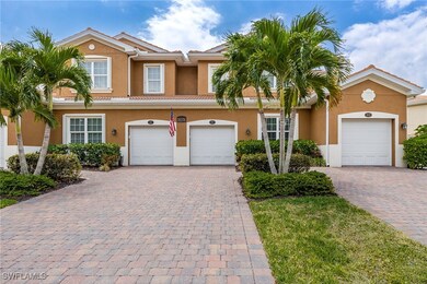 View of property featuring a garage, a tiled roof,