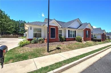 Single story home featuring brick siding, roof with shingles, and a front lawn