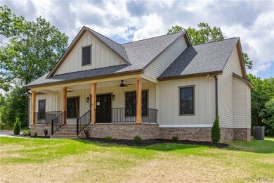 View of front of property featuring covered porch, central air condition unit, ceiling fan, and a front lawn