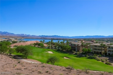 View of property's community featuring view of golf course, a yard, a water and mountain view, and a residential view