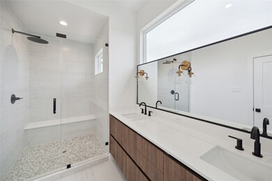 Elegant primary bathroom featuring a spacious glas