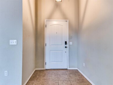 Foyer entrance with light tile floors