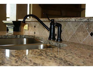 Kitchen. Under-mount stainless sink, granite, and 