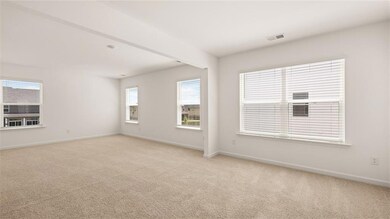 Carpeted empty room featuring baseboards and visib