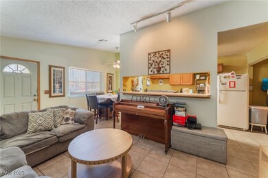 Living room with track lighting, ceiling fan, ligh