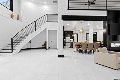 Entryway with a towering ceiling, visible vents, m