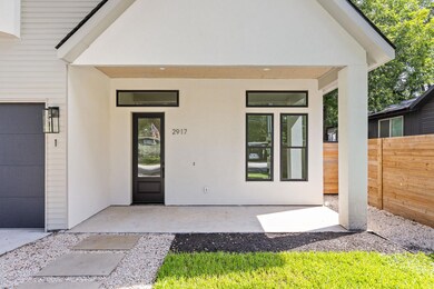 Property entrance with a garage and stucco siding