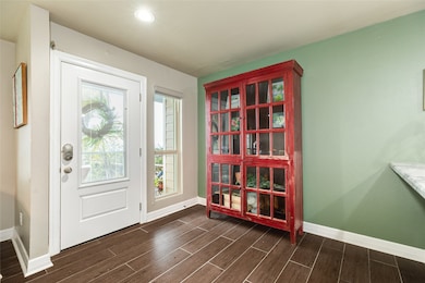 Entry is bright and the wood-look tile carries fro