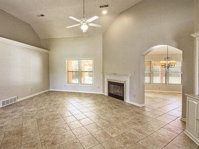 The greatroom features a fireplace and a vaulted c