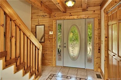 tiled entryway with lead glass front doorway
