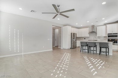 Kitchen featuring stainless steel appliances, wall