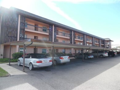 Condo building with carport directly in front of c