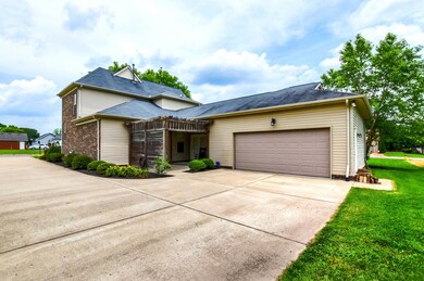 View of 2 car garage and covered patio space