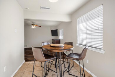 Tiled dining area with ceiling fan