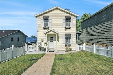 This picket fenced backyard is both quaint and practical.