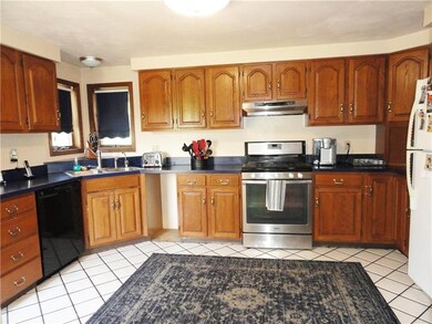Spacious kitchen with gas range, dishwasher, refri