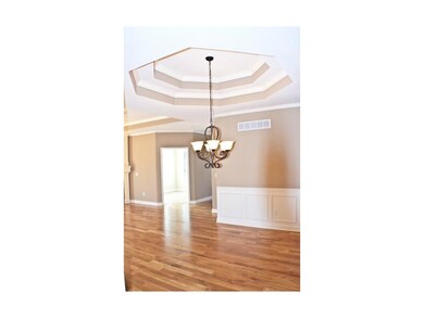 Gleaming hardwood floors and double coffered ceili
