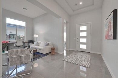 Entrance foyer featuring tile patterned flooring, a raised ceiling, and recessed lighting