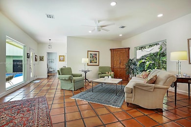 Picture windows bring in the landscape and pool views from every room