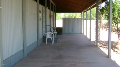 Full length covered patio/carport.