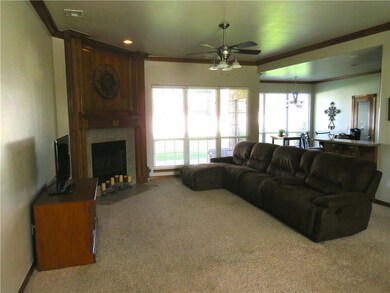 Large living room with fireplace and open to the k
