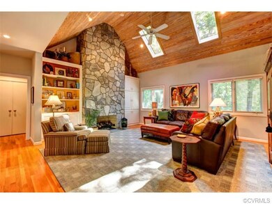 Two story family room with stone fireplace, two sk