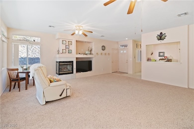 Great room featuring ceiling fan, a tile fireplace
