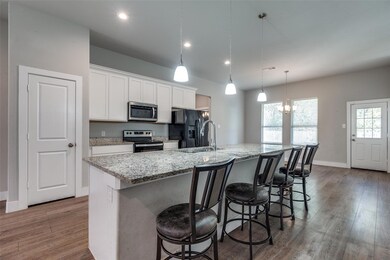 Kitchen featuring white cabinetry, a center island